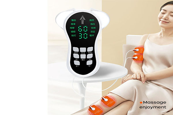 A physical therapist applying an EMS unit to a patient's leg